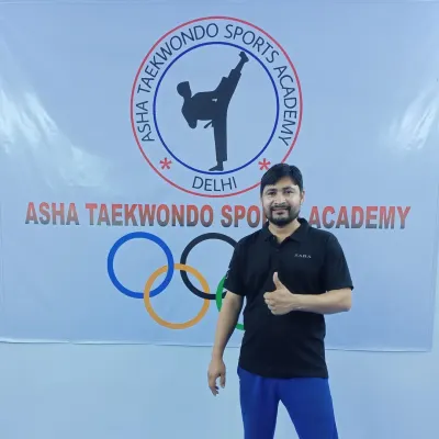 Standing in front of our academy's banner. I am proud of the community we have built and the students we train.