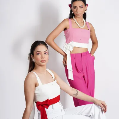 A dual-model shot for a contemporary brand, showcasing two coordinated but distinct looks. I focused on creating a visual dialogue between the models through complementary colors and contrasting accessories like bows and pearls.