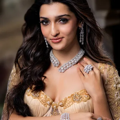 A classic glamour shot for a Mehta Emporium Jewellers campaign. The makeup features a sharp winged liner and luminous skin, while the hair is styled in voluminous waves to frame the face and highlight the diamond necklace.