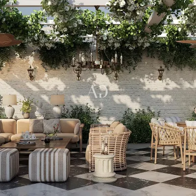 This terrace combines classic French design with the relaxed feel of outdoor living. The space features a black and white checkerboard floor, comfortable wicker and upholstered seating, and a pergola draped in white roses, evoking the tranquil charm of the French countryside.