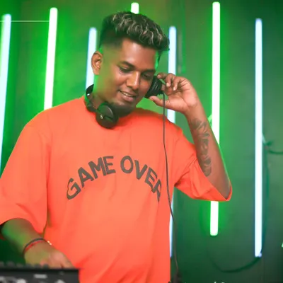 A candid shot of me listening to the mix on my headphones. This is me in my element, focused on the sound against a cool neon green backdrop.