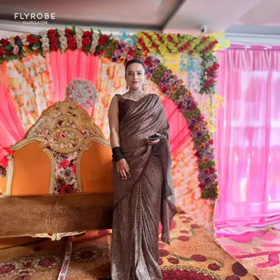Slay the festive season without breaking the bank. This client looks regal in a shimmering brown pre-draped saree, a hassle-free and glamorous option.