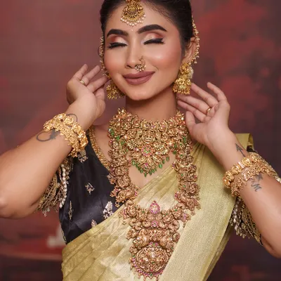 This golden tissue silk saree is a showstopper for any reception. I paired it with a contrasting black blouse that has heavy gold embroidery for a look that is both modern and regal.
