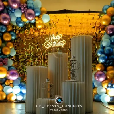 A glamorous birthday setup featuring a gold sequin shimmer wall and a colorful balloon frame. The custom pedestals and neon 'Happy Birthday' sign make this a fun and stylish centerpiece for any party.