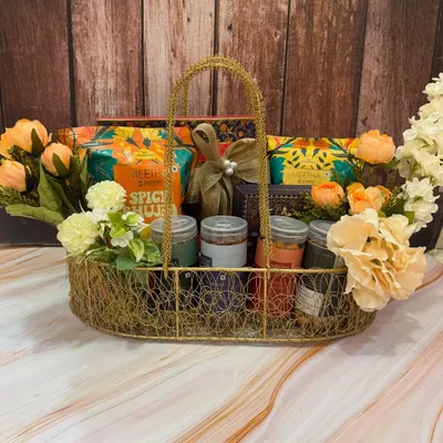 Have a 'chatpati and meethi' Rakhi with our desi snack hampers. This one is overflowing with a variety of traditional bites with a modern twist, all arranged in a beautiful wire basket with flowers.