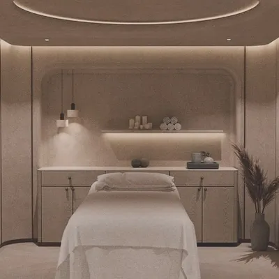 This private spa room is designed for ultimate relaxation. Soft, indirect lighting, a neutral color palette, and clean lines create a tranquil atmosphere reminiscent of a luxury wellness retreat.