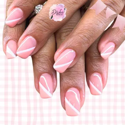 Soft, classy, and timeless. These pastel pink nails with crisp white diagonal lines are the perfect blend of elegance and simplicity.