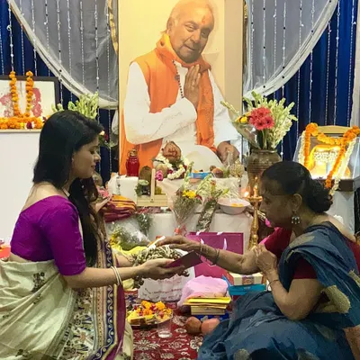 "The Guru and God are two forms of the same divinity." This moment from a Guru Purnima ceremony, receiving blessings from my guru Saswati didi in front of Maharaj ji's portrait, is a memory I will cherish forever.