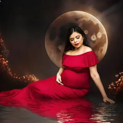 This portrait captures the magic of motherhood with a dramatic, fine art approach. I used a rich red gown and a creative moon backdrop to create a celestial, dream-like scene, focusing on the quiet and powerful connection between you and your baby.