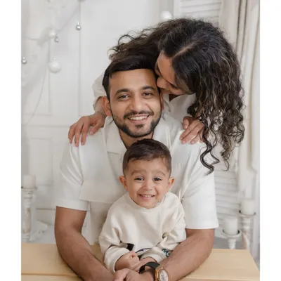A beautiful family portrait in our all-white "Winter Wonderland" Christmas set. The coordinated white outfits create a serene and elegant holiday card photo.