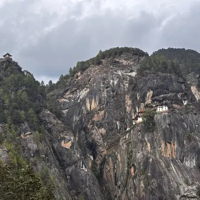This is the world famous Tiger’s Nest Monastery in Bhutan, seen from the trail. The monastery clings to a sheer cliff face, and the trek to reach it is the main highlight of my 7-day all-inclusive Bhutan trip. The view itself is worth the journey.