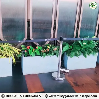 For the entrance at Skydeck, RR Nagar, we used modern, rectangular planters with a mix of flowering and foliage plants to create a vibrant and welcoming first impression for visitors.