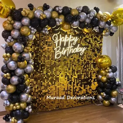 This premium birthday decoration features a stunning gold sequin wall as the backdrop. It's framed by a balloon garland in black, silver, and gold, with a neon 'Happy Birthday' sign for that extra touch of class.