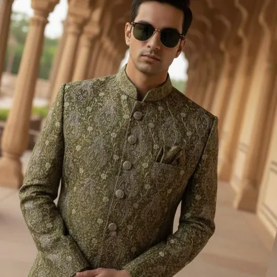 A closer look at the intricate silver and gold threadwork on our olive green sherwani. The craftsmanship is exceptional, giving the piece a subtle shimmer and a truly regal feel.