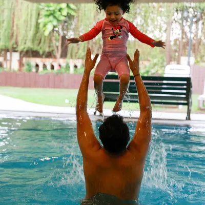 Pure joy in its most energetic form! An at-home lifestyle shoot can even end with a splash in the pool. I love capturing the fun and unscripted moments of a family just being themselves.
