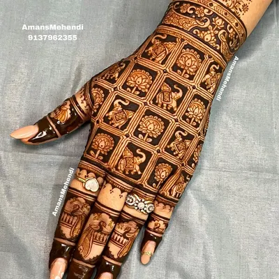 A full back-hand design featuring a precise grid pattern. Each square is filled with alternating elephant and lotus motifs, creating a rich, quilt-like effect.