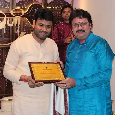 Honoring a guest artist with a plaque after his remarkable performance at our monthly baithak.