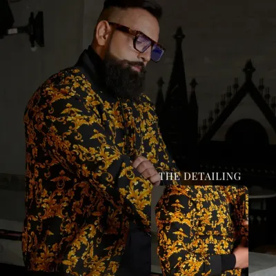 This jacket is luxuriously bold. The rich baroque pattern in gold on a black base is crafted for those who wear confidence as a second skin. The inset shows the fine detailing of the print.