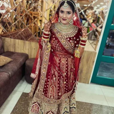 Our bride looks absolutely regal in a classic red and gold velvet lehenga. We focused on creating a timeless look with bold red lips, defined eyes, and traditional jewelry, ensuring she was picture-perfect for her wedding ceremony.