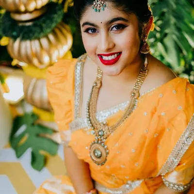 A stunning picture from a Haldi ceremony. The client is glowing in her yellow saree, and I paired it with a classic red lip and defined eyes for a look that is both traditional and vibrant.