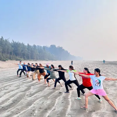 A beautiful moment from our yoga retreat in Umargaon. Practicing Virabhadrasana II (Warrior 2) together on the beach as the sun sets.