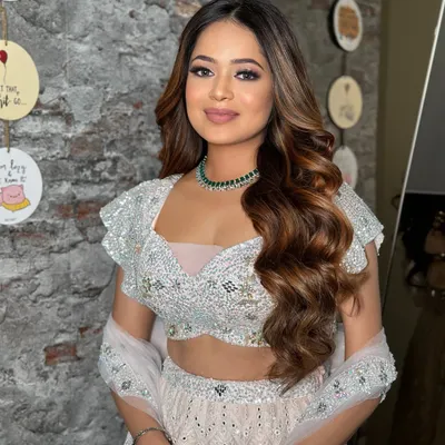 A beautiful half-up style with soft, flowing waves for a Roka ceremony. The hair is given a gentle lift at the crown for volume, creating a look that is both fresh and celebratory.