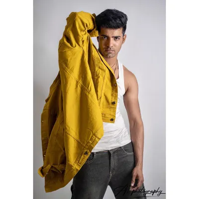 A strong studio portrait with a pop of color from the yellow jacket. This type of image is great for a model's portfolio, showing how they can carry a bold fashion piece.