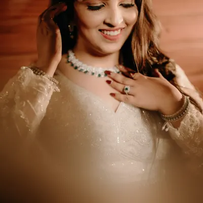 A radiant bridal portrait of Nikita. Her joyful smile and the soft lighting create a warm and timeless image that captures her happiness.