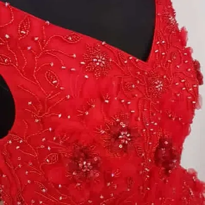 This close-up shows the intricate beadwork and embroidery I do by hand. I take a lot of care to ensure the finishing on every party gown is perfect.