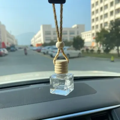 Here is my hanging air freshener in its natural habitat, keeping the car interior fresh. The compact glass bottle and wooden cap are designed to be unobtrusive and stylish.