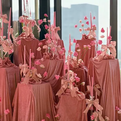 An absolutely breathtaking bridal shower, where the entire space is draped in luxurious blush pink velvet and adorned with pink candles and flowers.