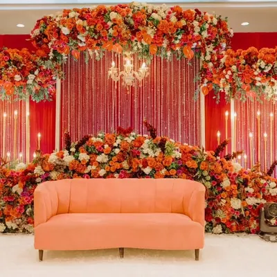 For Gladys and Jerin's reception, we went for bold romance. The stage was enveloped in a sea of rich red florals, accented with warm candlelights and a statement chandelier, creating a passionate and luxurious ambiance for their celebration.