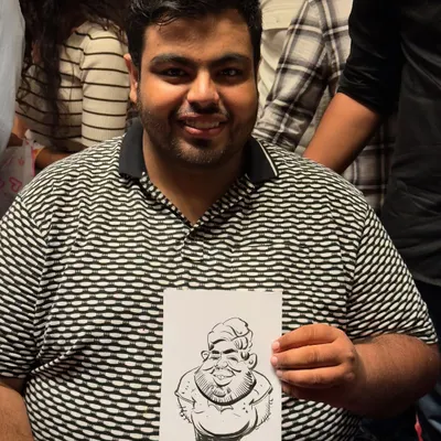 Big smiles, bigger heads. That’s the magic of caricature. This happy guest is holding his fun, personalized souvenir.