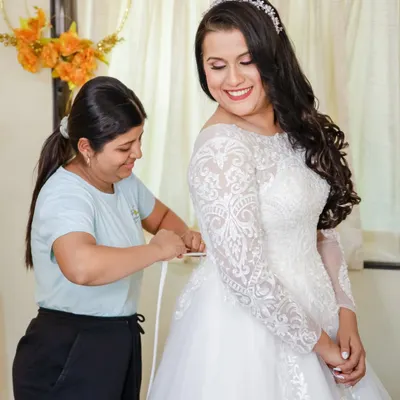 A happy moment as the bride gets into her gown. My work is done, and her smile shows she feels confident and beautiful, ready for her wedding.