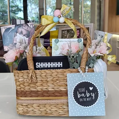 A perfect hamper to pamper a 'Mom To Be'. This basket is filled with goodies for both mom and baby, including an eye mask, photos of the parents, and a 'Baby on the Way' card.