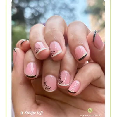 A modern take on the French manicure, this design combines a classic pink base with delicate butterfly decals and fine black and white tip lines.