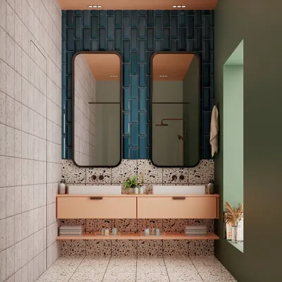 A full view of our playful and polished bathroom design. The combination of soft peach cabinetry, deep blue vertical tiles, and terrazzo flooring creates a space that is full of personality and style.