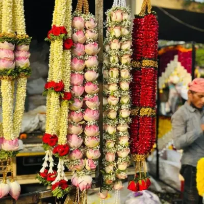I specialize in creating all types of fresh flower garlands. This photo shows some of my premium garlands, including ones made with lotus buds, roses, and jasmine, perfect for the bride and groom or for decorating deities.