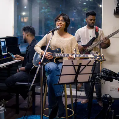 A full band setup during our artist showcase, featuring Anushka on vocals and guitar. Our space is equipped to handle everything from a solo act to a complete band with professional sound.