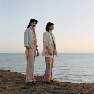 A wide shot from a menswear editorial on the coast. I chose this location for its dramatic cliffs and soft sunset light, creating a romantic and expansive backdrop for the collection.