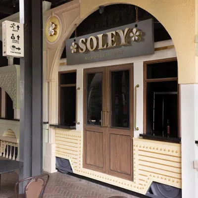 The entrance to Soley European Cafe, where a custom-built tram car facade serves as a unique gateway to the culinary experience inside. This design element immediately transports visitors and sets the narrative for the space.