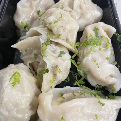 My home-cooked Chicken Steam Momos are a simple delight. Each one is filled with a juicy chicken mince and steamed until soft, then garnished with fresh coriander.