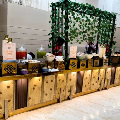 Good food, great setup, and warm vibes all around. This is a look at one of our beautiful buffet counters, complete with decorative elements and a refreshing drinks station.