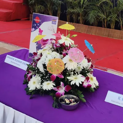 A close-up of a custom centerpiece from the Japanese-themed AON event. The floral arrangement, complete with miniature paper umbrellas, is a small detail that reinforces the overall theme and shows a commitment to cohesive design.