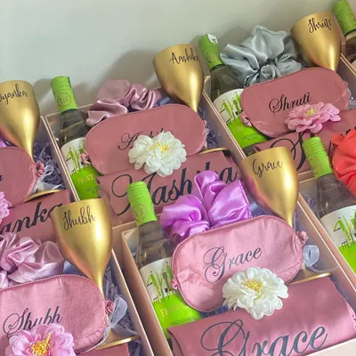 A toast to your bridal party! This bridesmaid hamper includes a personalized unbreakable wine glass, a mini bottle of white wine, a custom satin eye mask and robe, and a matching scrunchie. It's the perfect way to pop the question to your girls.