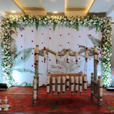 A breathtaking floral setup for a traditional South Indian naming ceremony. We used a botanical-print backdrop, a lush floral frame, and an antique-style cradle to create a sacred and beautiful atmosphere.