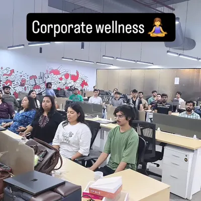 A moment of shared calm during a corporate wellness session. We practice mindfulness to help clear the mind and reset for a more productive afternoon.