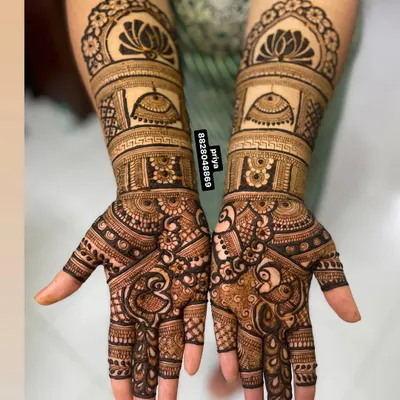 This design features royal palace domes and graceful peacocks, giving it a majestic feel. The combination of bold figures and delicate fill-work is perfect for a bride who wants a traditional yet standout design.