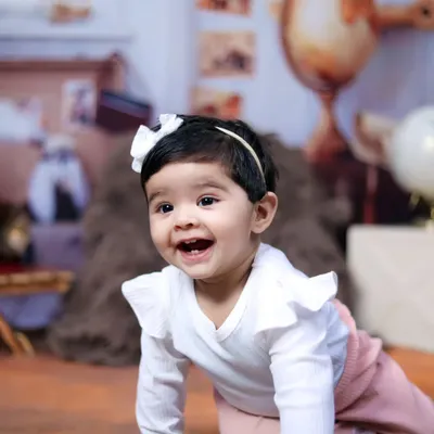 The pure joy of a baby on the move. This crawling shot captures a happy and curious expression during a sitter session.