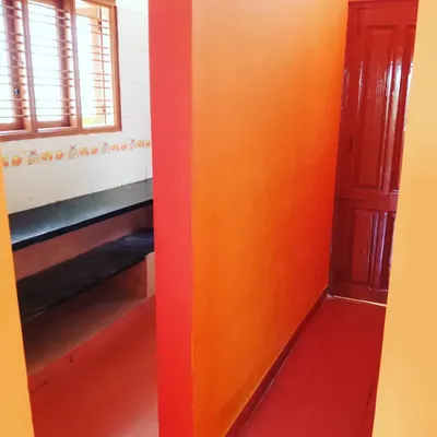 Using bold colors like this orange can add a lot of energy to a space. This photo shows a hallway I painted, where the accent wall creates a warm and welcoming path through the home.